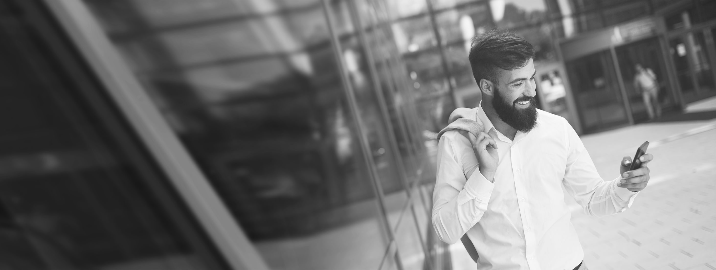 Smiling man looking at phone