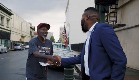 mayor shaking hand of constituent on city street