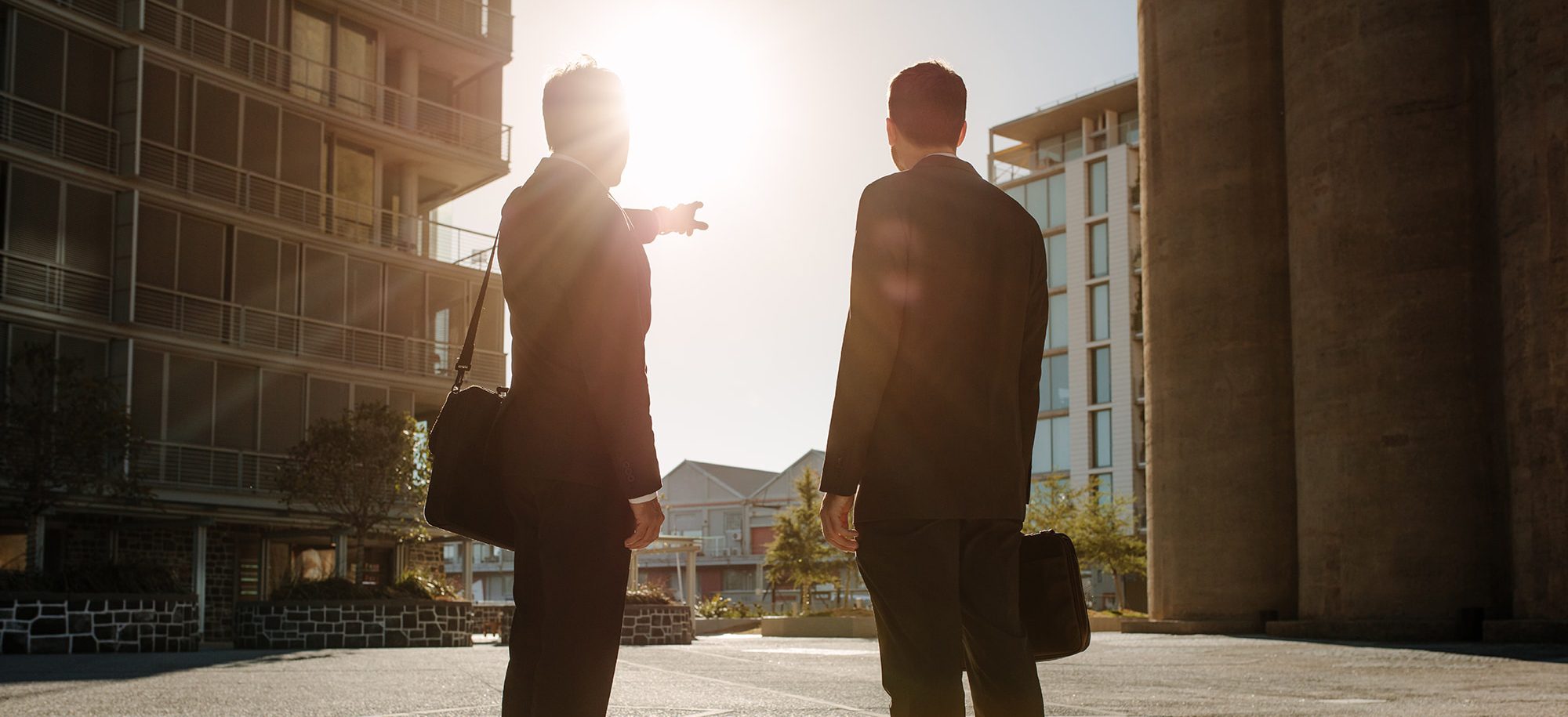 two men looking over city plot